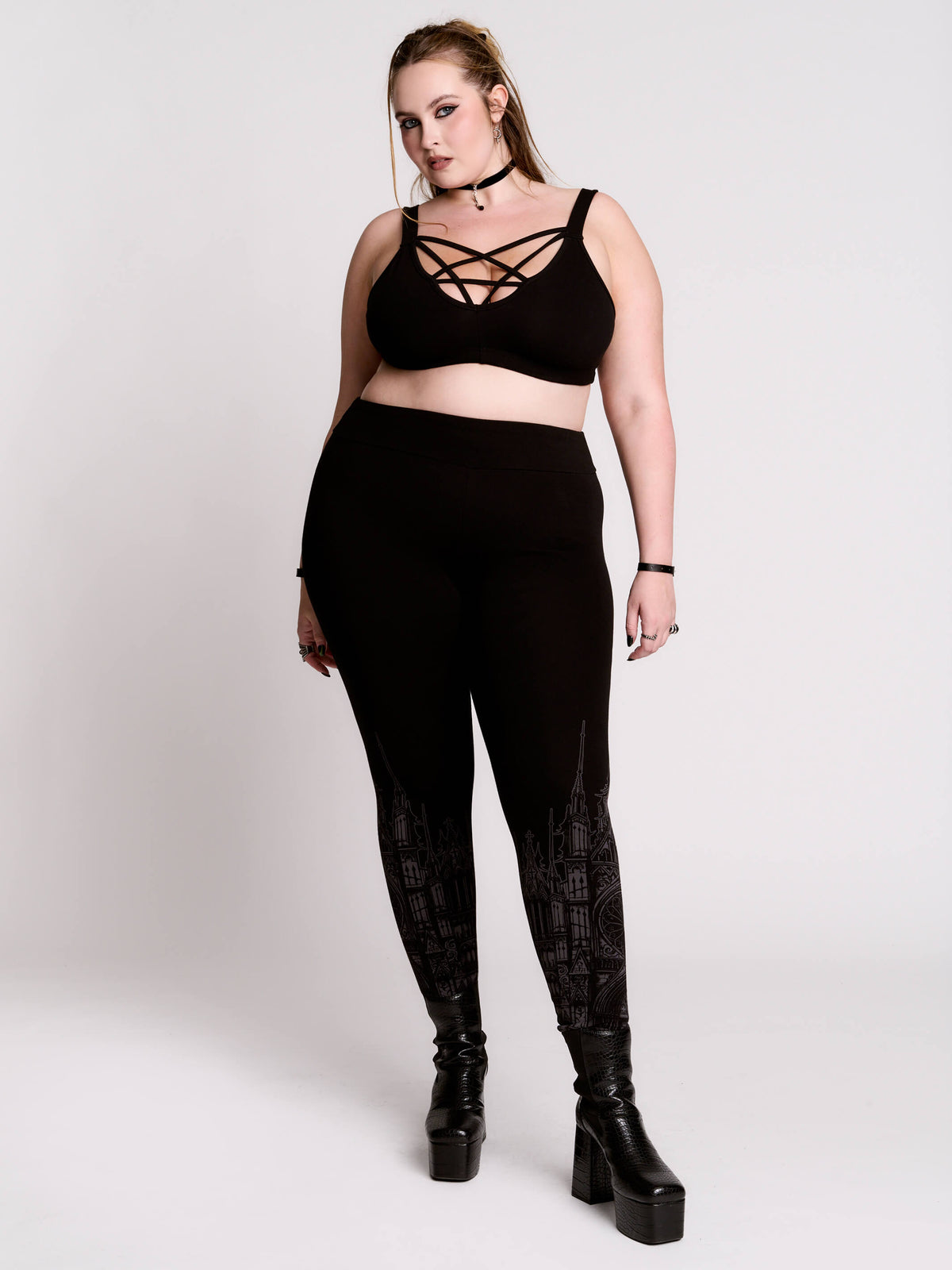 Black leggings with a dark gray gothic cathedral line-art print down the legs.