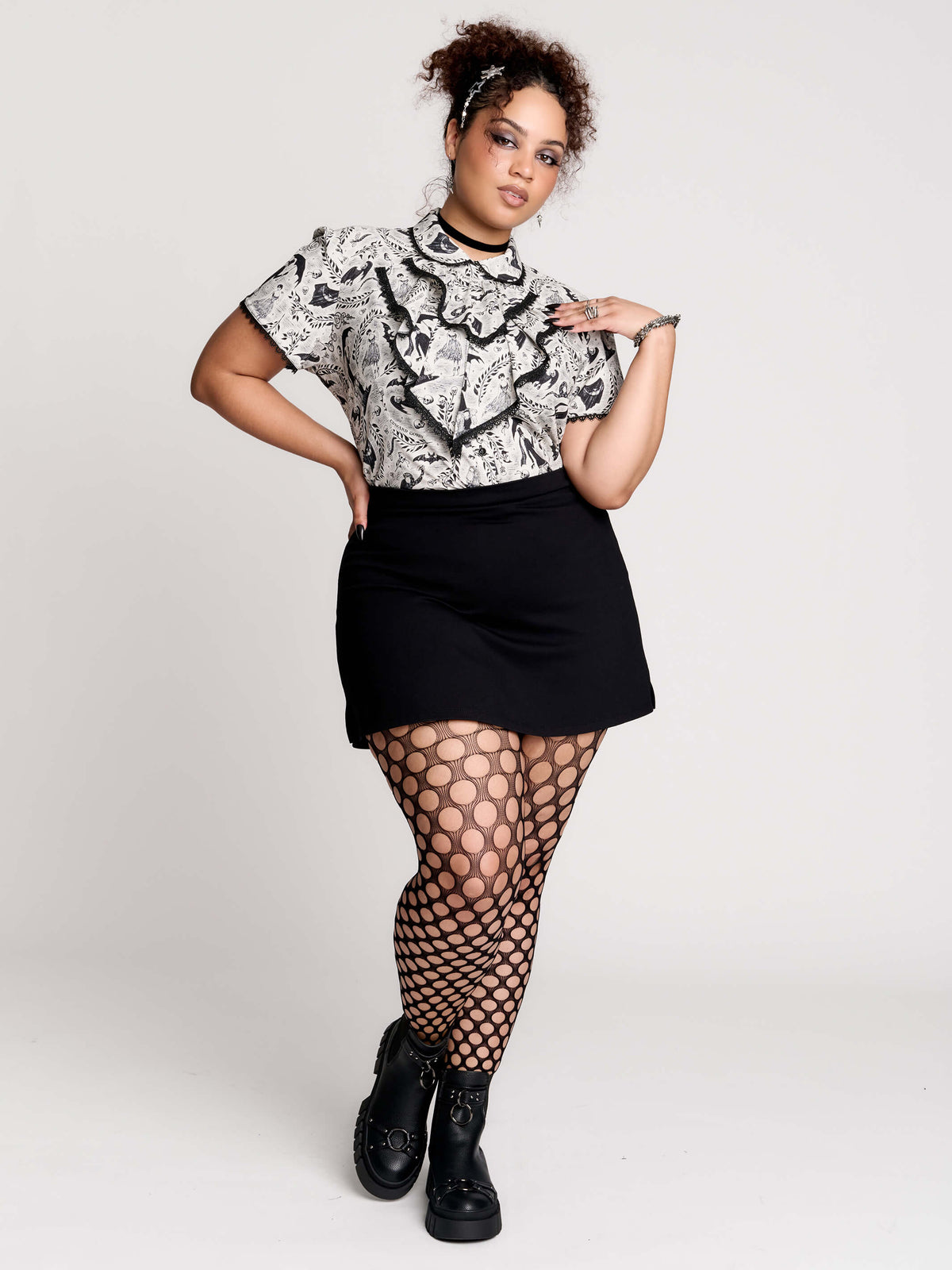 a black and white patterned ruffled blouse