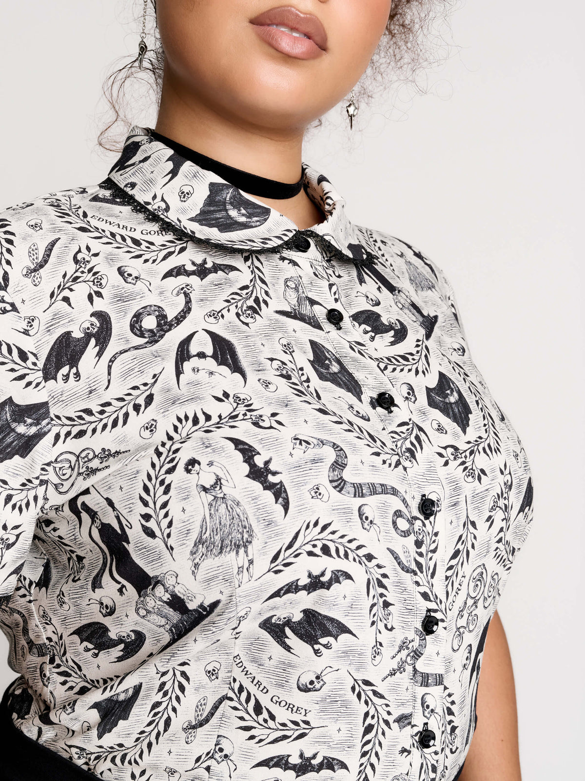 a black and white patterned ruffled blouse