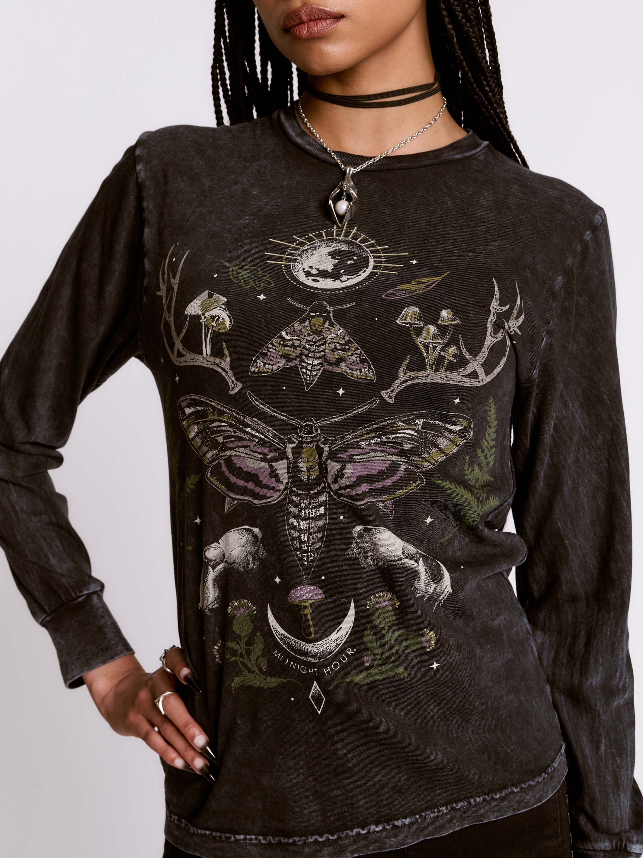 Black long-sleeve shirt with intricate designs featuring a moth and celestial elements on a plain background.