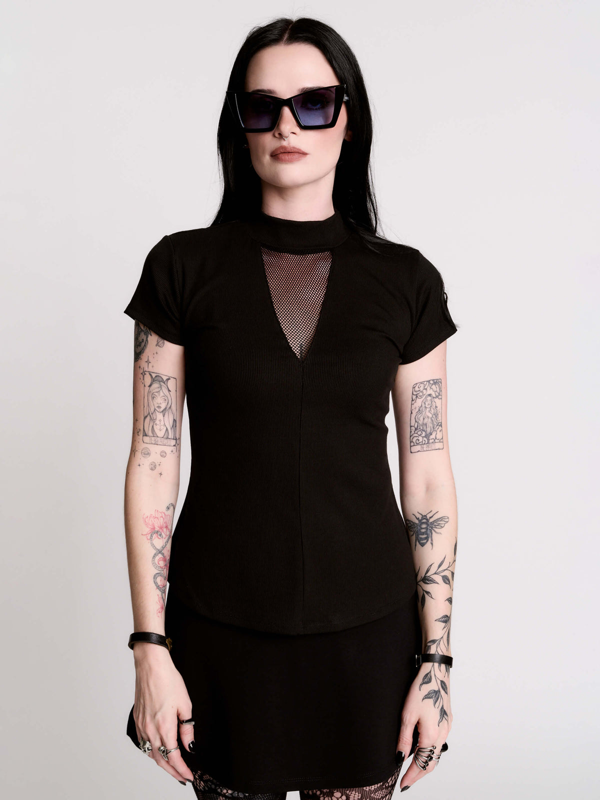 A black short-sleeve mock neck top with a fishnet mesh chest panel.