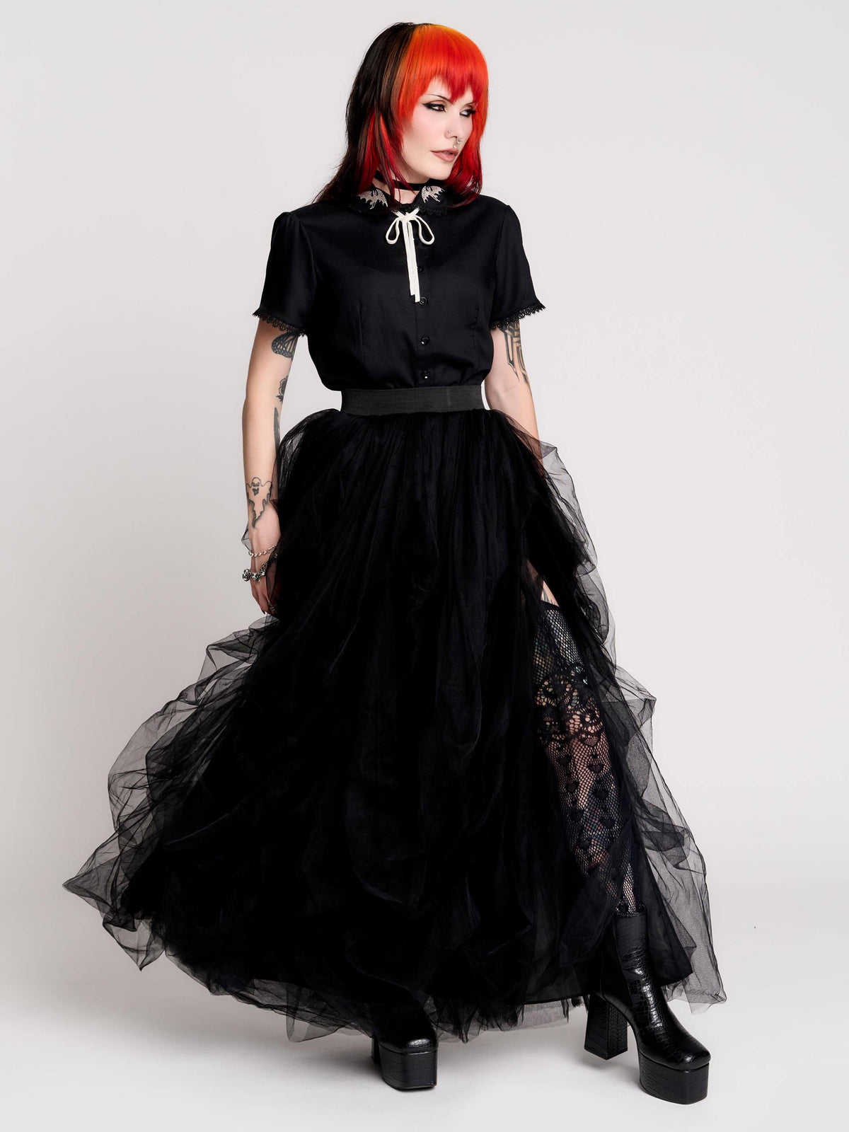 a voluminous layered black tulle skirt.