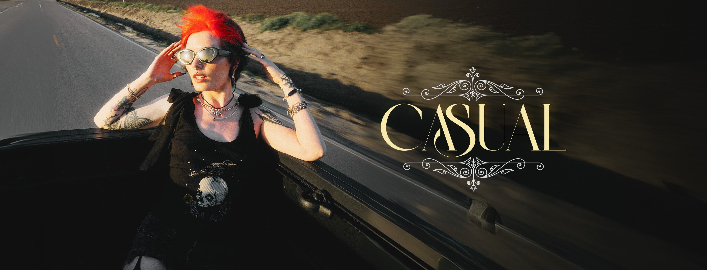 Person with red hair sitting on a car, wearing sunglasses and a black tank top, with 'Casual' text overlay.