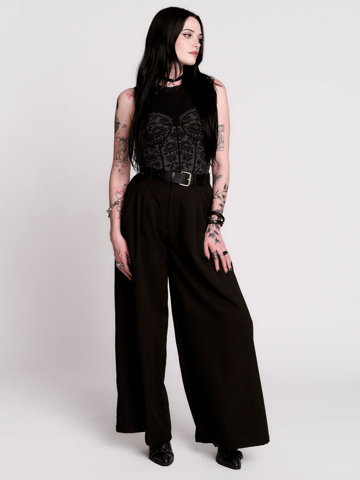 A black sleeveless top with a printed floral lace corset in light grey.