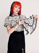 a black and white patterned ruffled blouse