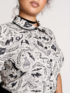  a black and white patterned ruffled blouse