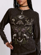Black long-sleeve shirt with intricate designs featuring a moth and celestial elements on a plain background.