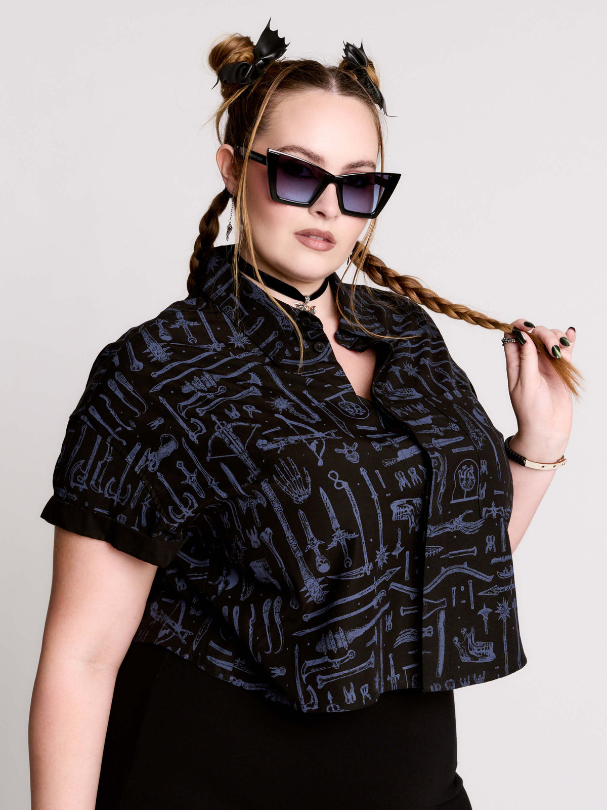 Armory Cropped Shirt is a boxy, cropped, short-sleeve button-down that mixes crisp classic shirting with dark, gothic illustration. 
