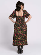 Woman wearing a floral dress with a white background