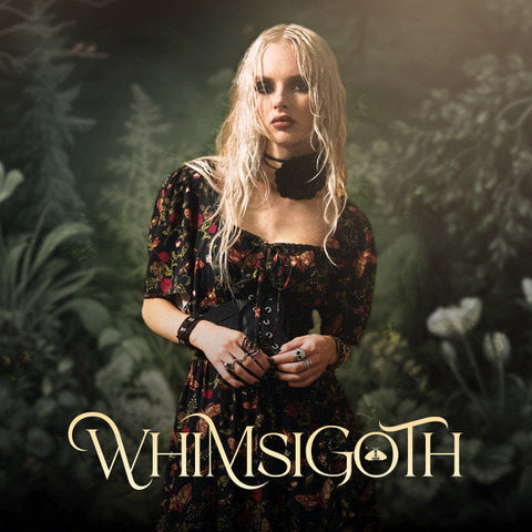 Person in a dark, floral dress with 'WHIMSIGOOTH' text in a forest setting